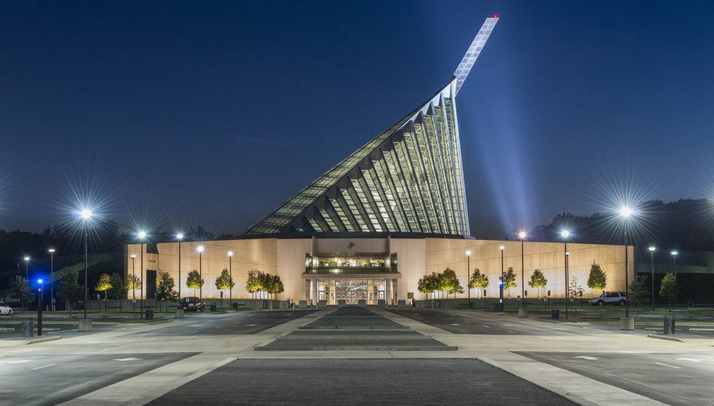 a large building lit up at night with street lights