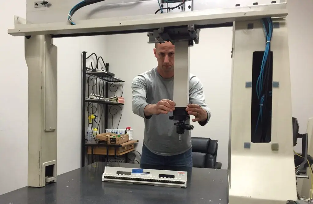 a man standing in front of a machine