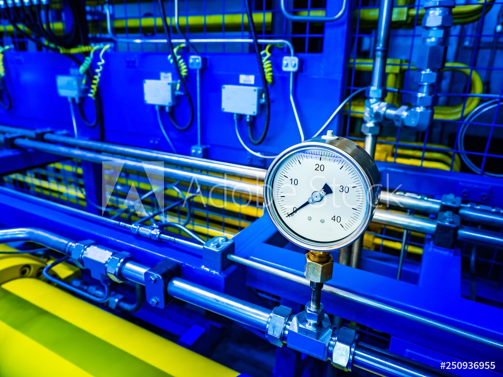 a pressure gauge in front of an industrial machine