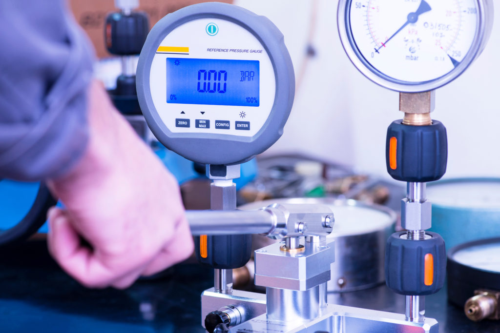 a man is working on a machine with a digital display