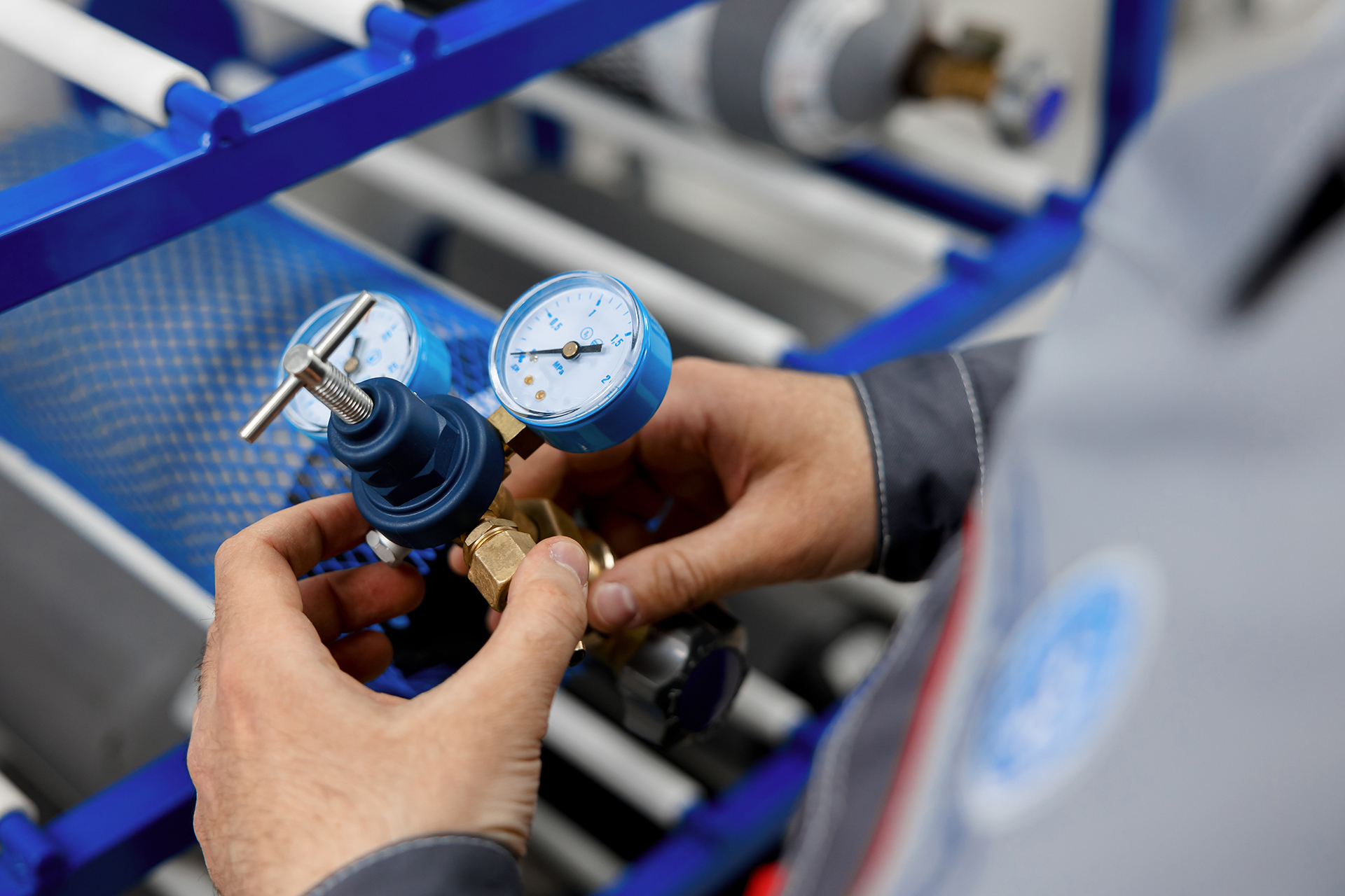 a man is working on a machine with two gauges