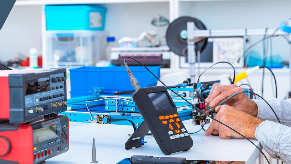 a man working on an electronic device in a lab