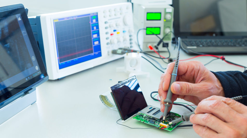 a man is working on an electronic device