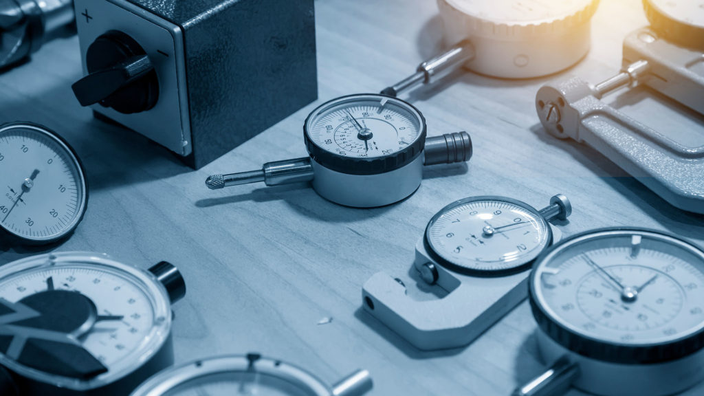 a variety of gauges and dials on a table. How to Calibrate Torque Tools
