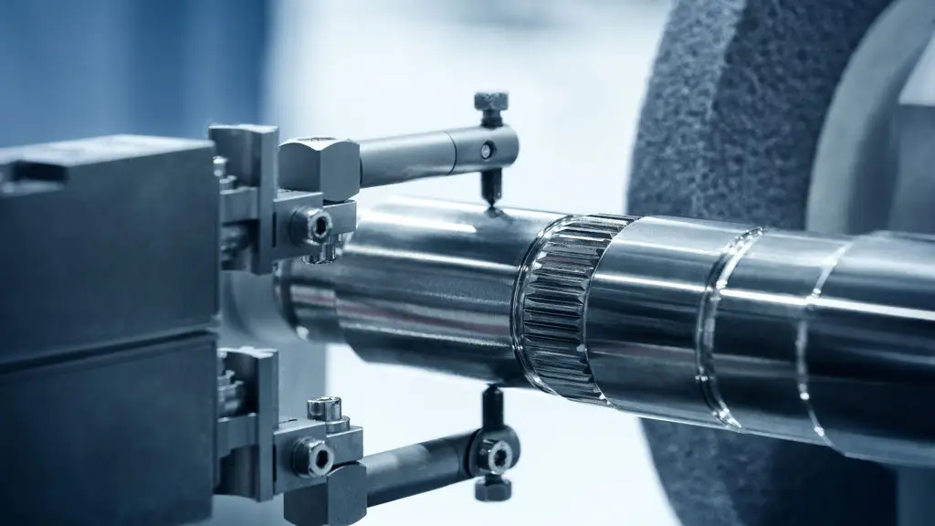 a close up of a machine that is cutting a piece of metal