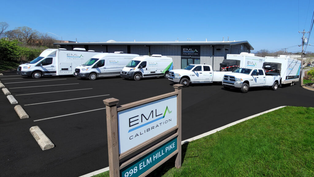 a group of white trucks parked in a parking lot