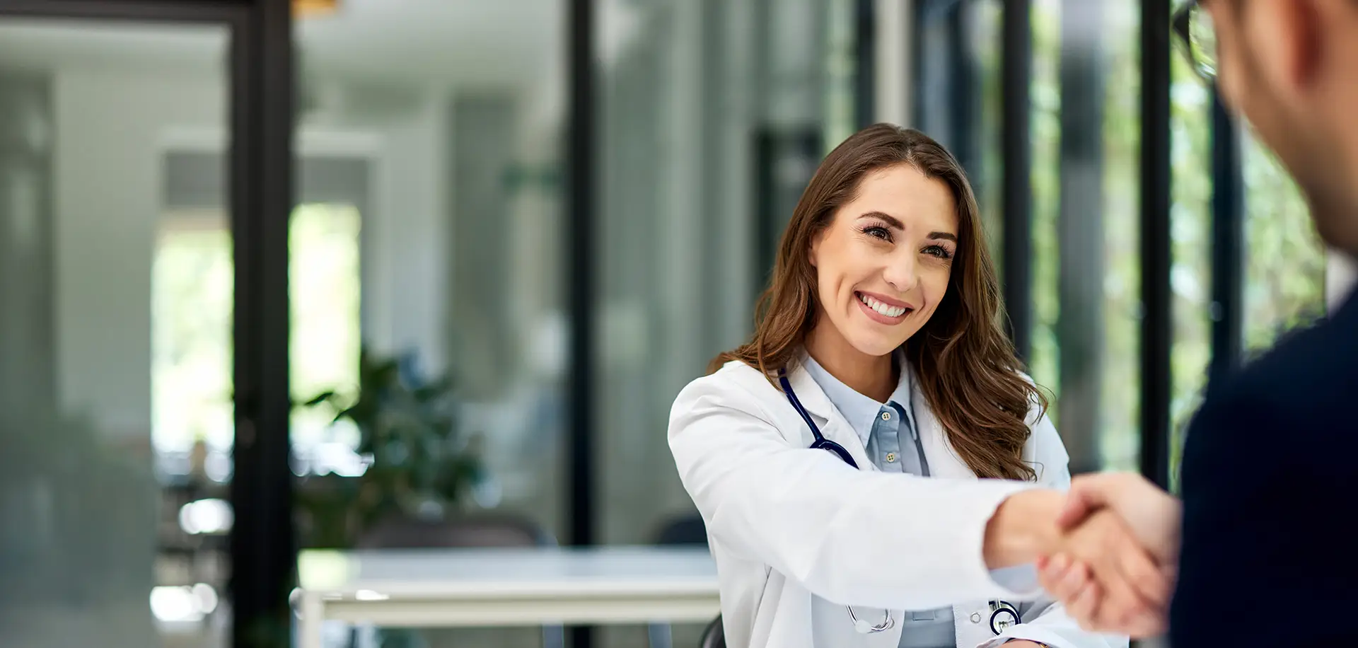female doctor male patient handshake